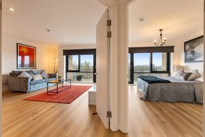 Uma sala de estar moderna com sofá, mesa de centro e tapete vermelho.