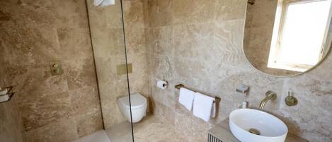 A modern bathroom with a bathtub, a sink, and a toilet.