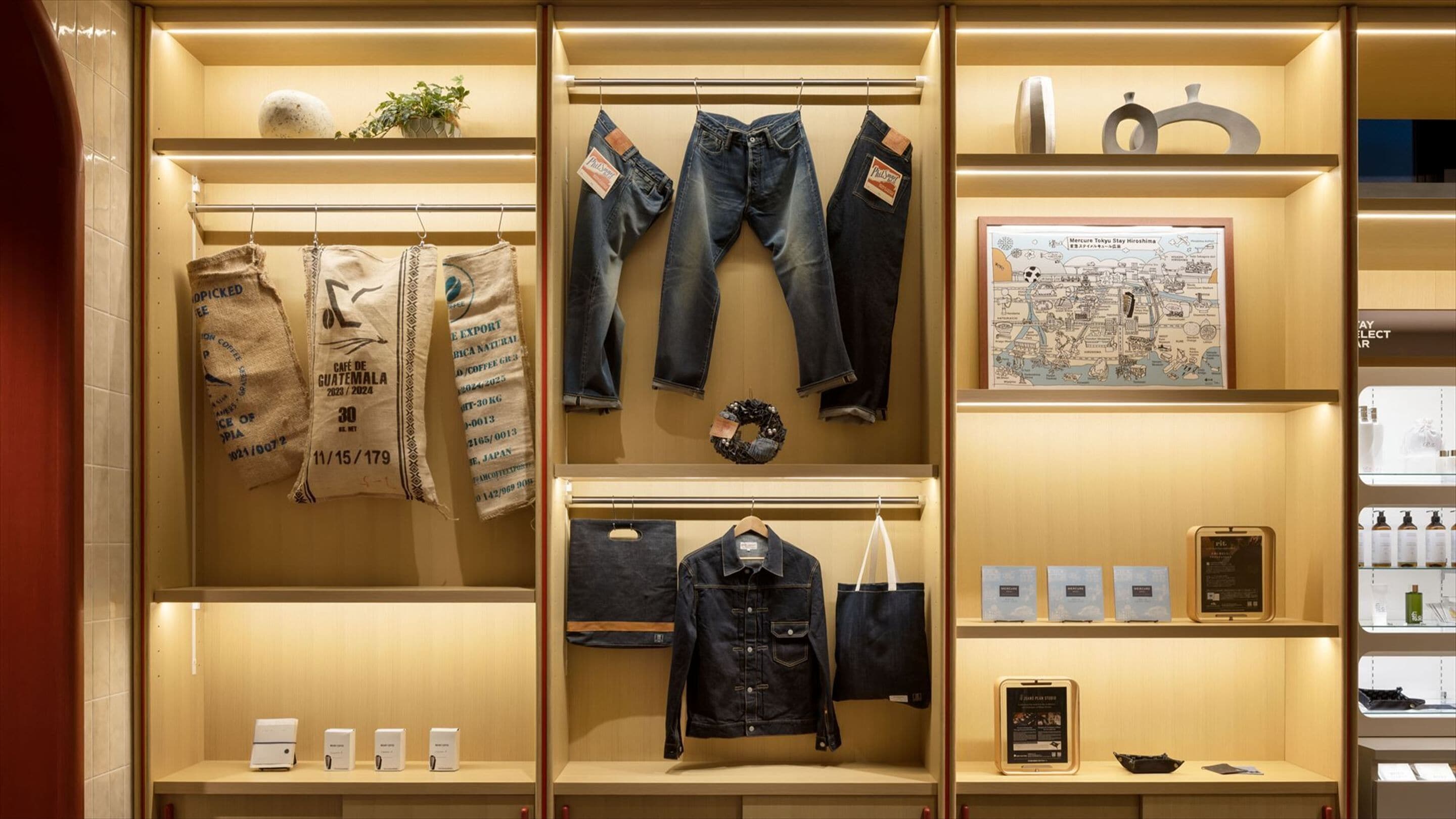 A retail display with jeans, coffee bags, a map, and a smartphone.
