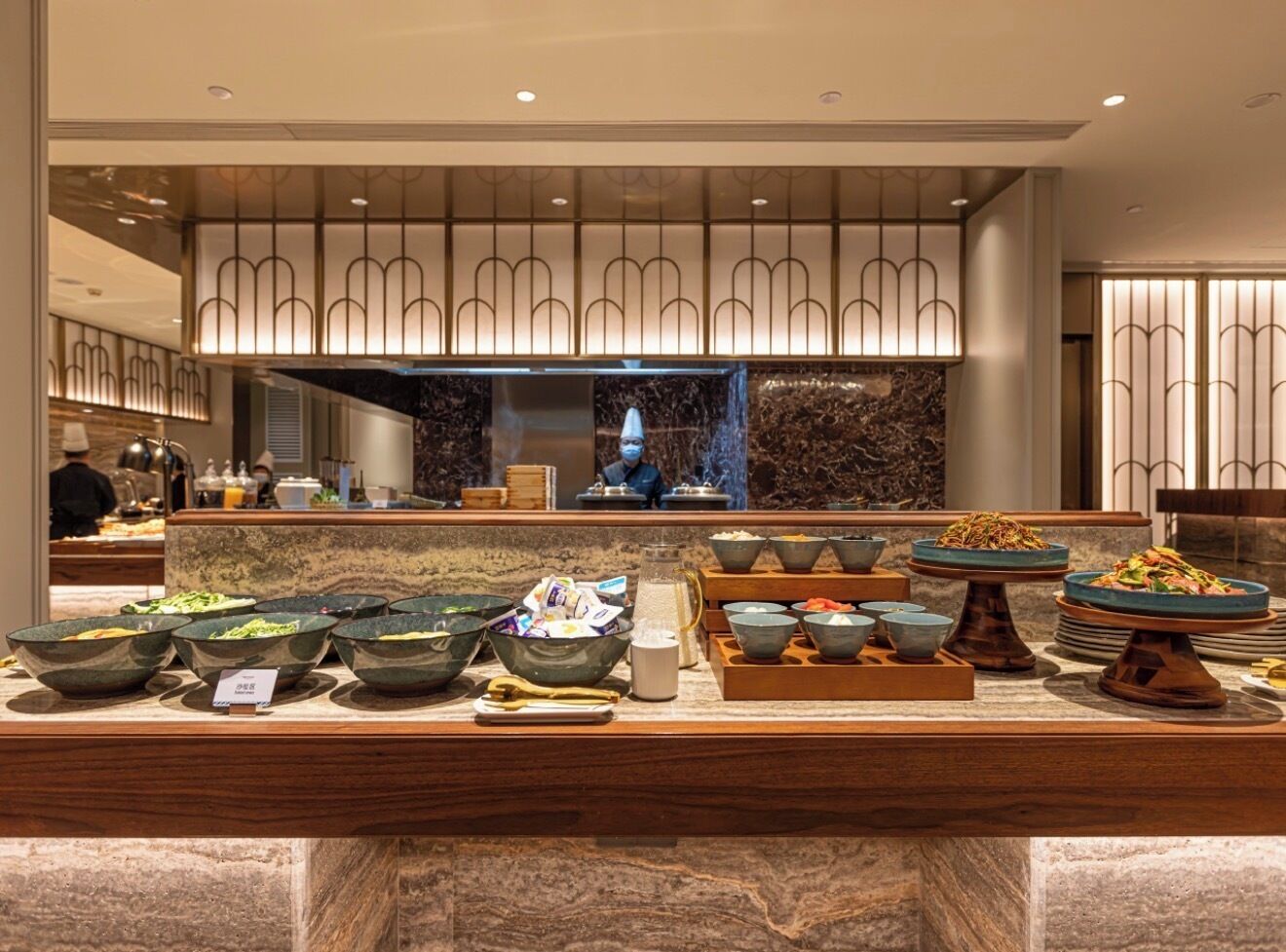 A buffet area with various food bowls and a water dispenser.