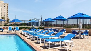 A poolside area with lounge chairs and umbrellas. - 2BR Gulf-view Resort Condo: Suntide III - Unit 607 (South Padre Island)