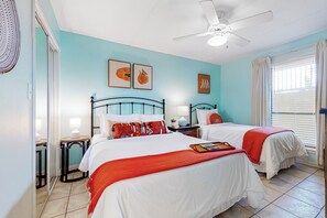A bedroom with two beds, a ceiling fan, and artwork on the walls. - Gulf-view Condo w/ Perks: Suntide III - Unit 205 (South Padre Island)