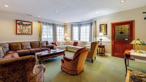 A spacious living room with a sectional sofa, a plush armchair, and a coffee table. - 'the Pickford House' - Luxury Central Coast Stay! (Cambria)
