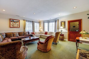 A spacious living room with a sectional sofa, a plush armchair, and a coffee table. - 'the Pickford House' - Luxury Central Coast Stay! (Cambria)