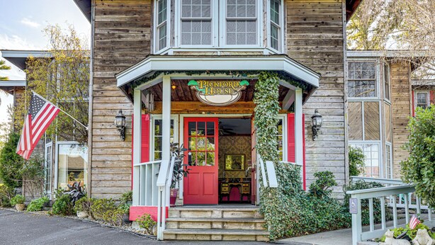 A wooden building with a red door, a sign reading "Pickford House," and an American flag. - 'the Pickford House' - Luxury Central Coast Stay! (Cambria)