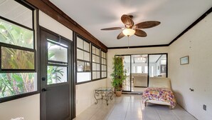 A room with a bed, a ceiling fan, a window, and a door. - Private Beach & Pool Access! Fort Myers Getaway (Fort Myers)