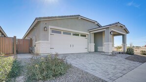 A modern two-story house with a garage, a covered porch, and a well-maintained driveway. - Serene Outdoor Space: Group Getaway in Maricopa! (Maricopa)