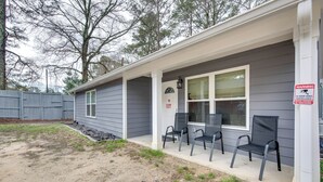 A house with a porch, three chairs, a warning sign, and a window. - Easy I-85 Access! Quiet Fairburn Extended Stay (Fairburn)