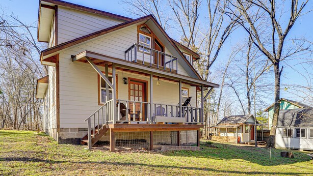 A two-story house with a balcony, a front porch, and a small attached garage. - Bring Your Boat! Woodsy Cottage Near Fayetteville (Fayetteville)