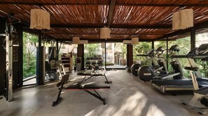 A gym with treadmills, elliptical machines, and weight equipment. - Siwa Jungle Romance C1-002 Beach Club Access (Tulum)