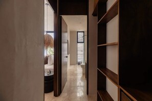 A hallway with a sofa, a coffee table, and a window with blinds. - Casa De Oro Jungle Villa Minutes from beach (Tulum)
