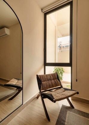 A room with a large window, a chair, and a mirror. - Nahara Jungle Chic Retreat Near the Beach (Tulum)