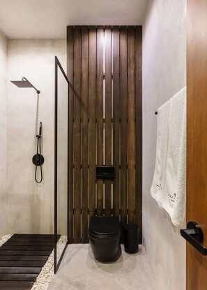 A modern bathroom with a wooden slat wall, a shower, a toilet, and a towel rack. - Villa Anunna Luxe Tulum Villa Beach Club Access (Tulum)