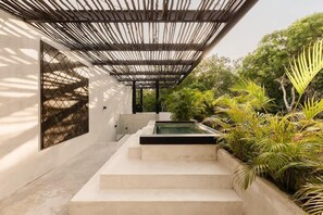 A modern outdoor space with a pool, steps, and lush greenery. - Villa Anunna Luxe Tulum Villa Beach Club Access (Tulum)