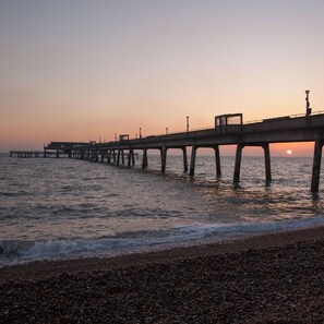A pier extending into calm waters with a sunset in the background. - Country House near Deal & Sandwich (Tilmanstone)