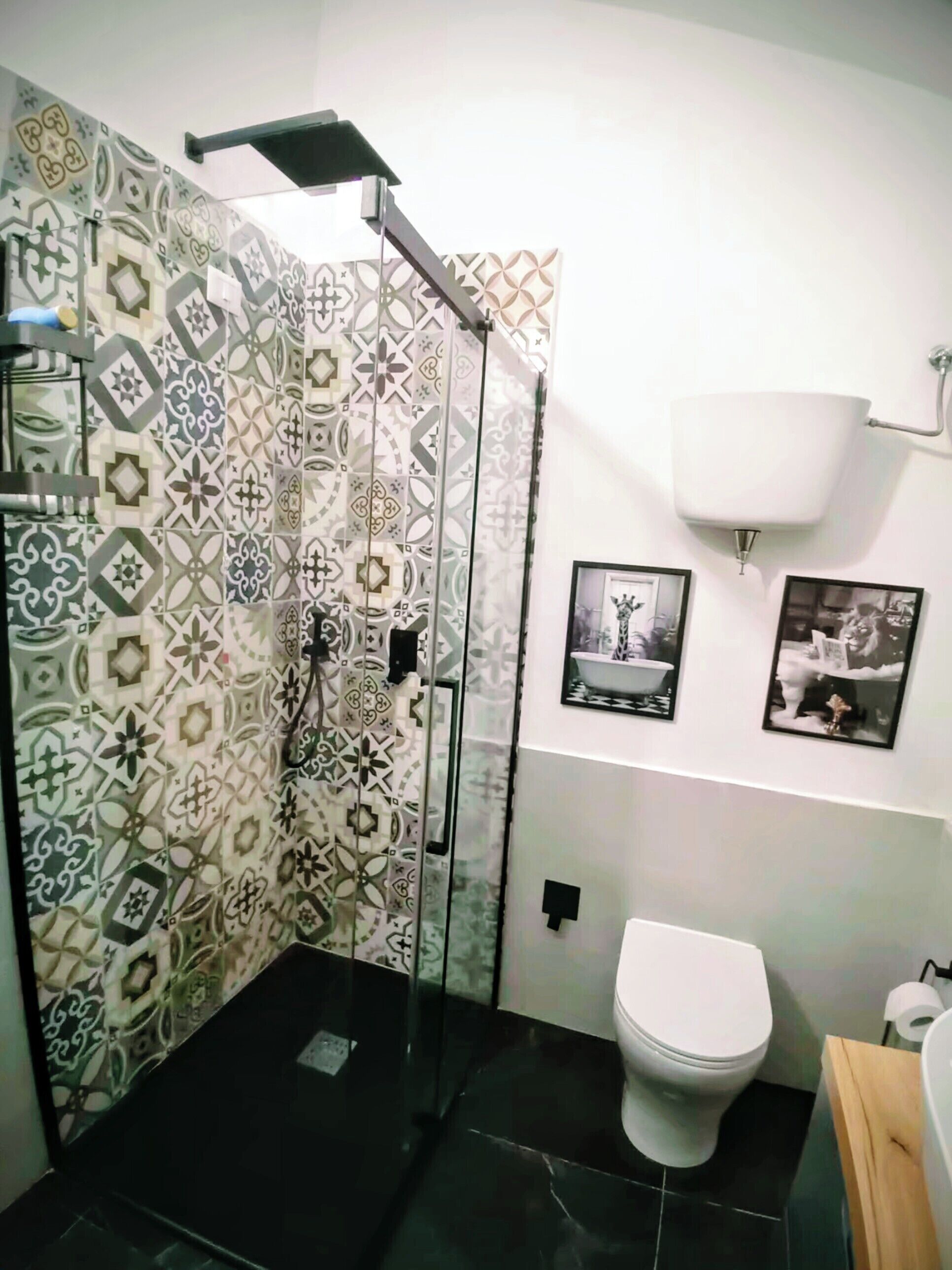 A bathroom with a shower, toilet, and sink.