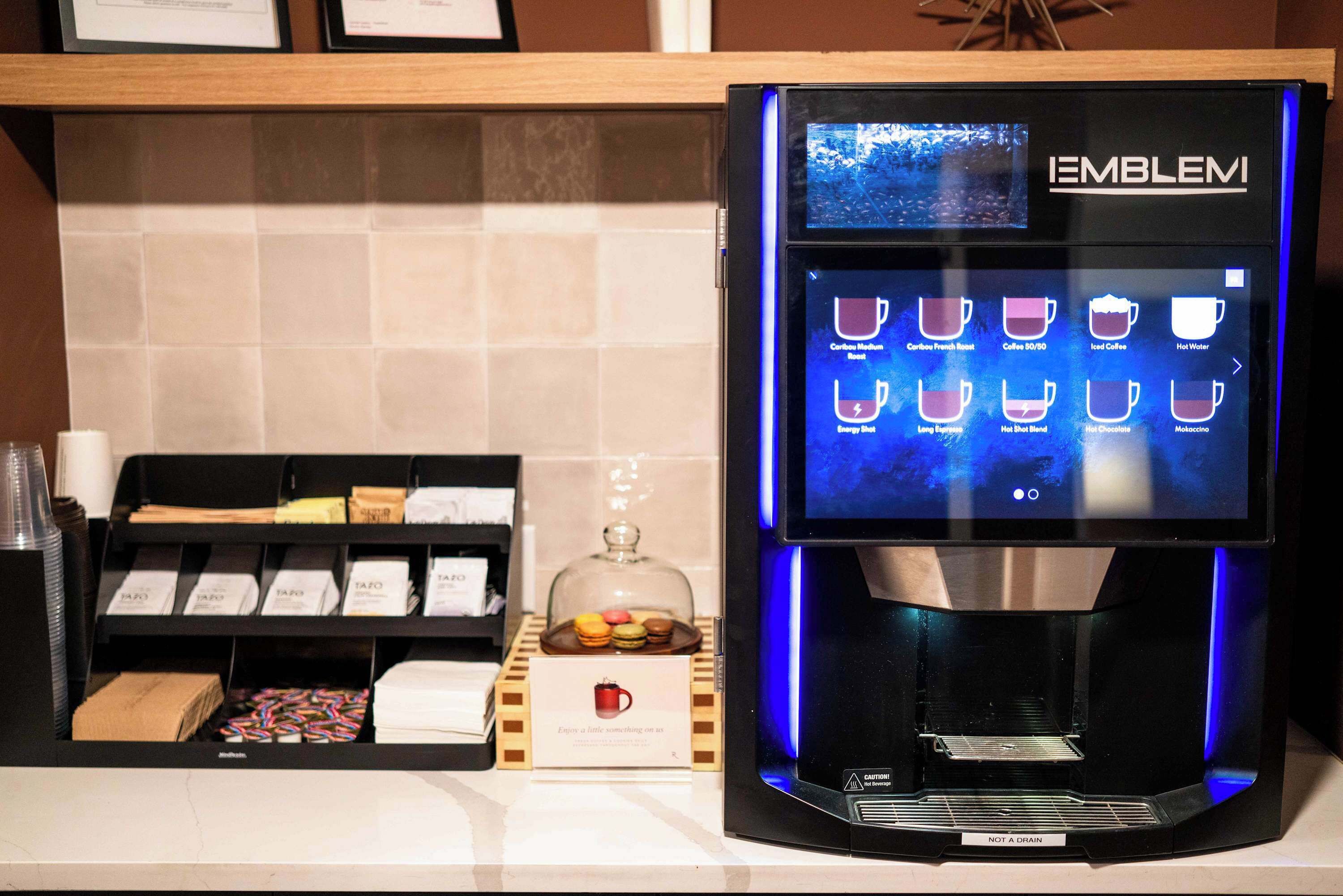 A coffee machine with a digital display and a selection of coffee options.