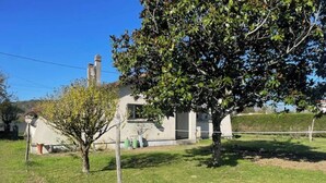 A house with a well-maintained lawn, a tree, and a chimney. - L'ECRIN DE JOSELIA, 60m2 renovated family home in Périgord Vert (QUINSAC)