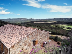A stone building with a tiled roof, a wooden door, and a small window. - Contemporary sheepfold with heated swimming pool (Sotta)