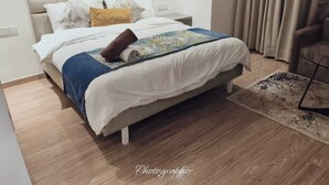 Un dormitorio moderno con cama, mesita de noche y una silla.