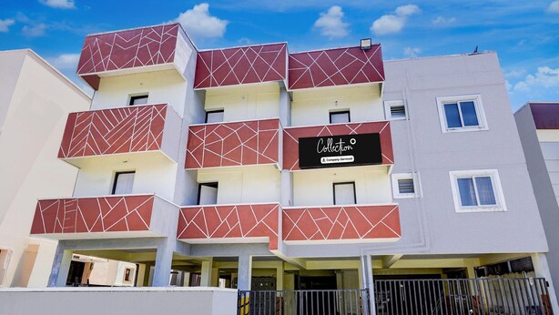 A multi-story building with geometric patterns on the balconies, a sign reading "Collection," and a gated entrance. - Super Collection O Sathyabama University (Chennai)