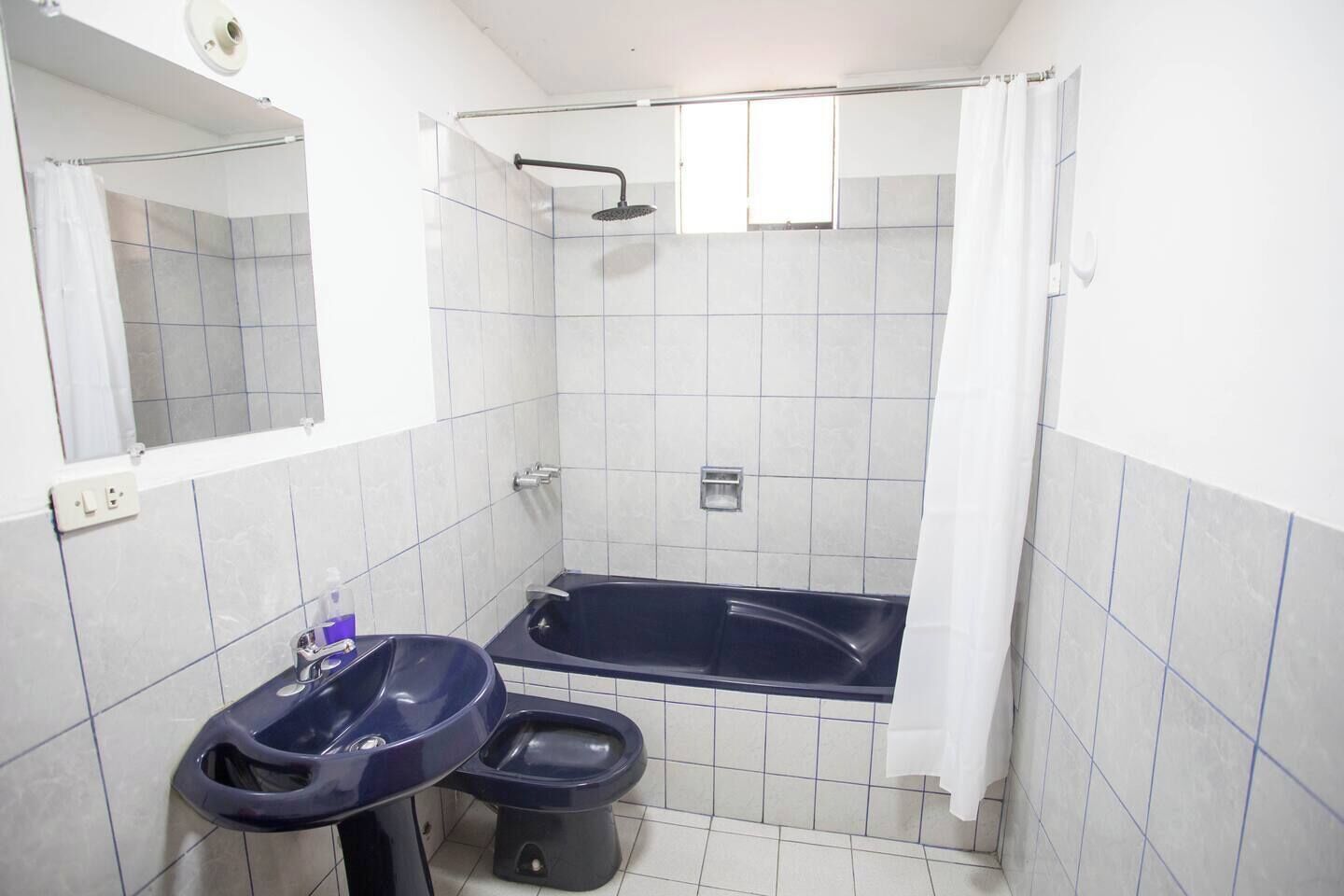 A small bathroom with a bathtub, a sink, and a toilet.