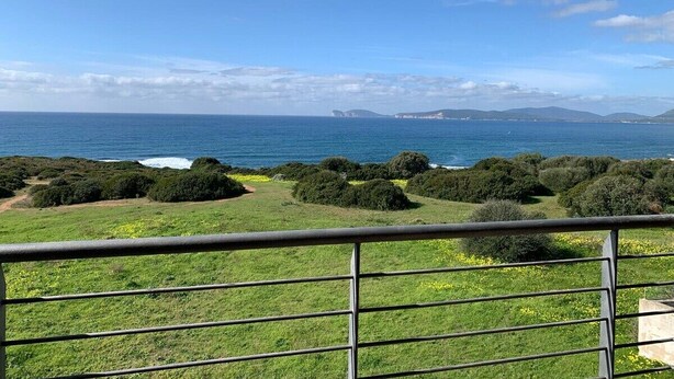 A coastal landscape with a clear view of the sea and distant mountains. - The Terrace on the Gulf of Alghero 2 (Alghero)