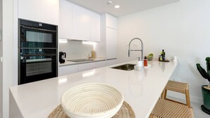A modern kitchen with a central island, built-in oven, and stainless steel appliances. - Luxury getaway with terrace and private pool (Marbella)