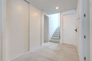 A hallway with a staircase leading to a door. - Luxury vacation with a terrace and private pool (Marbella)