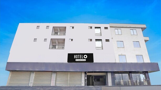 Ein modernes Hotelgebäude mit einem Schild, auf dem 'HOTELO Company-Serviced' steht.