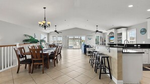 A spacious kitchen with a dining area, a bar, and a large island. - Murrells Inlet - 163 It's Five O'Clock Somewhere (Murrells Inlet)