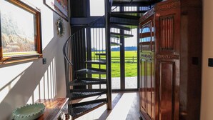 A staircase leading to a balcony with a view of a green field. - The Corn Silo (Ipswich)