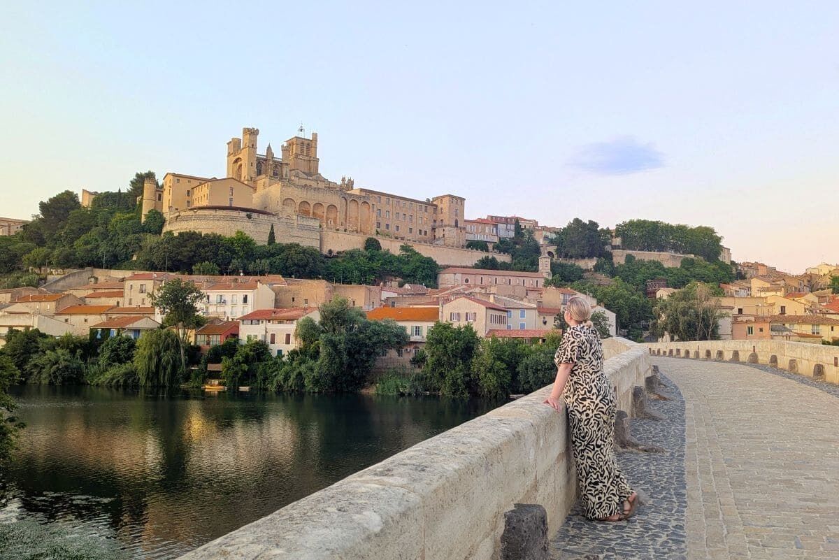 A bridge with a historic building in the background.