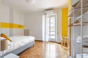 A bedroom with a bed, a chair, a wardrobe, and a radiator. - La Terrazza di Roma - Two Bedroom Apartment, Sleeps 6 (Rome)