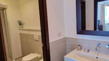 Een douche, een haardroger, een bidet, handdoeken
