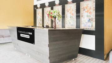A reception desk with a sign reading "Townhouse Oak & Company Serviced".