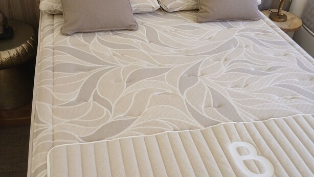 A neatly made bed with a patterned bedspread, two pillows, and a bedside lamp. - Superb accommodation (La Cala del Moral)