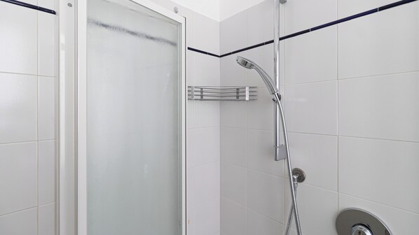 A modern shower with a glass door, a handheld showerhead, and a wall-mounted control panel. - Italianway Comfort - Sant' Ambrogio 2 (Milan)