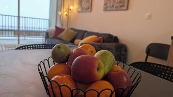 A fruit bowl on a table with oranges and apples.
