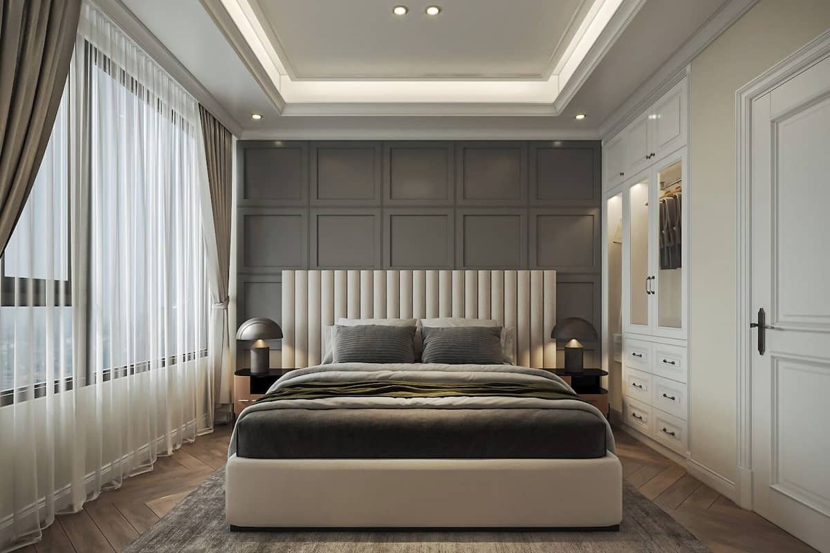 A modern bedroom with a large bed, a wardrobe, and a nightstand with lamps.