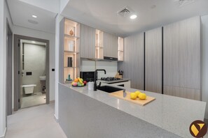 Full-sized fridge, microwave, oven, stovetop - Vogue | Al Serh Residences Near Circle Mall JVC (Dubai)