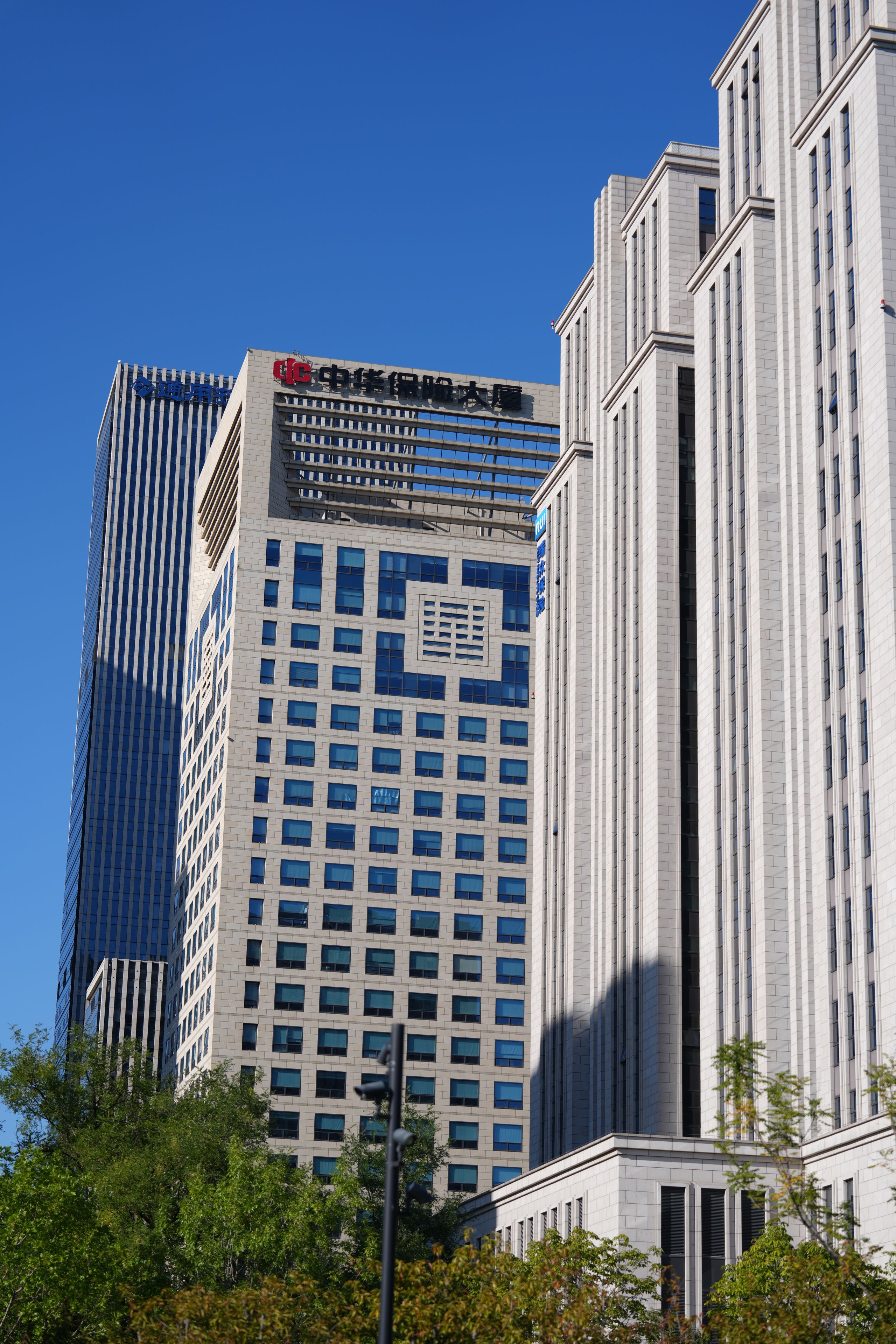 A modern building with a prominent sign and a clear blue sky in the background.