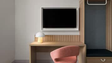 A modern room with a wooden desk, a pink chair, a white lamp, and a black screen on the wall.