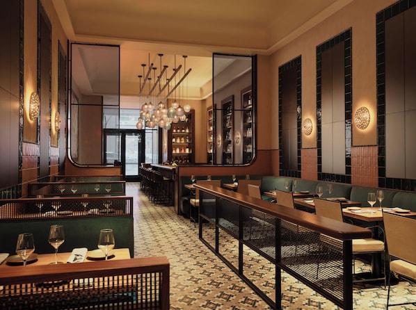 A restaurant with high ceilings, hanging pendant lights, and a patterned floor. - Kimpton Era Midtown New York By Ihg (New York)