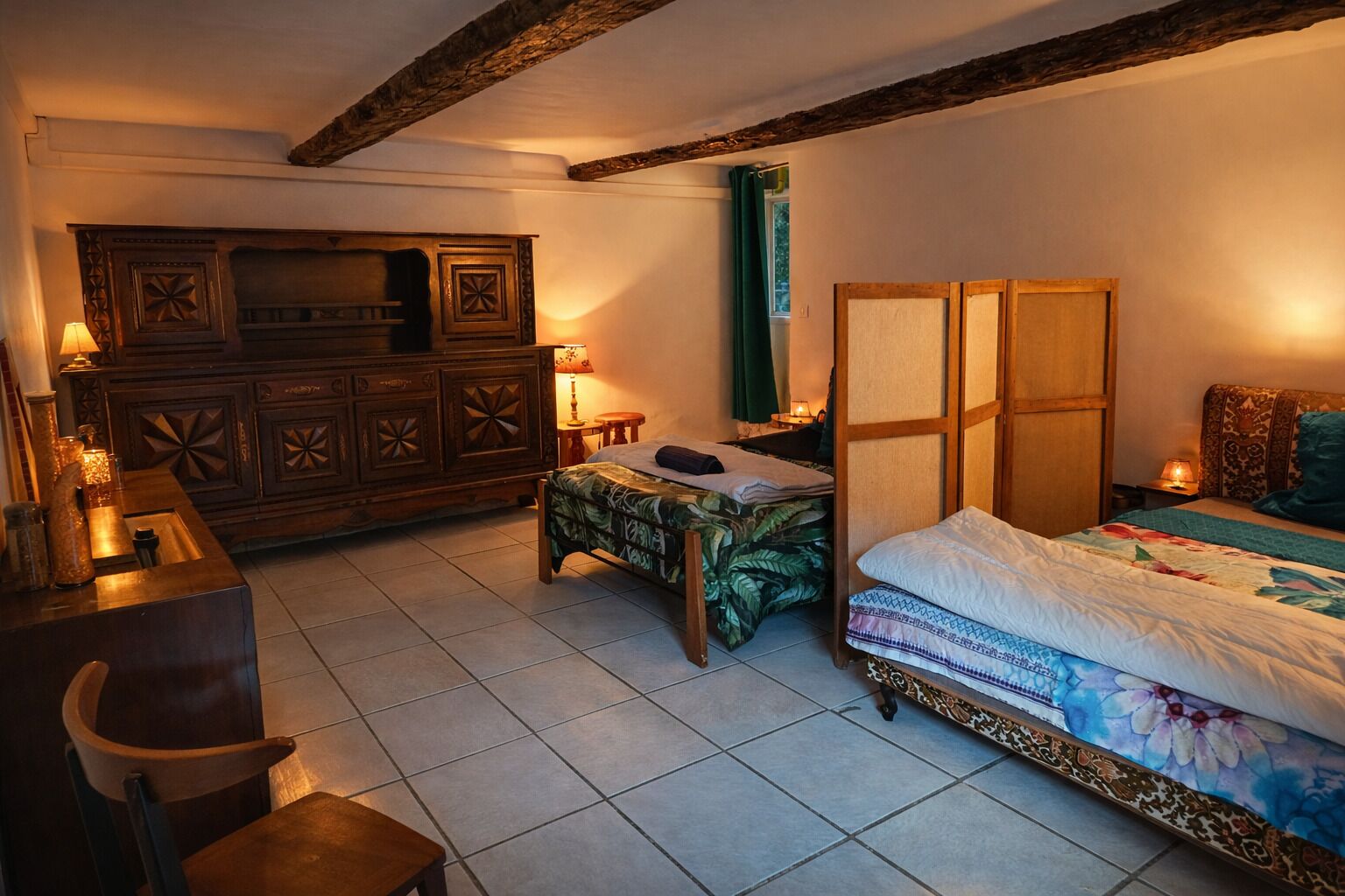 A traditional room with a wooden bed, a desk, and a cabinet.