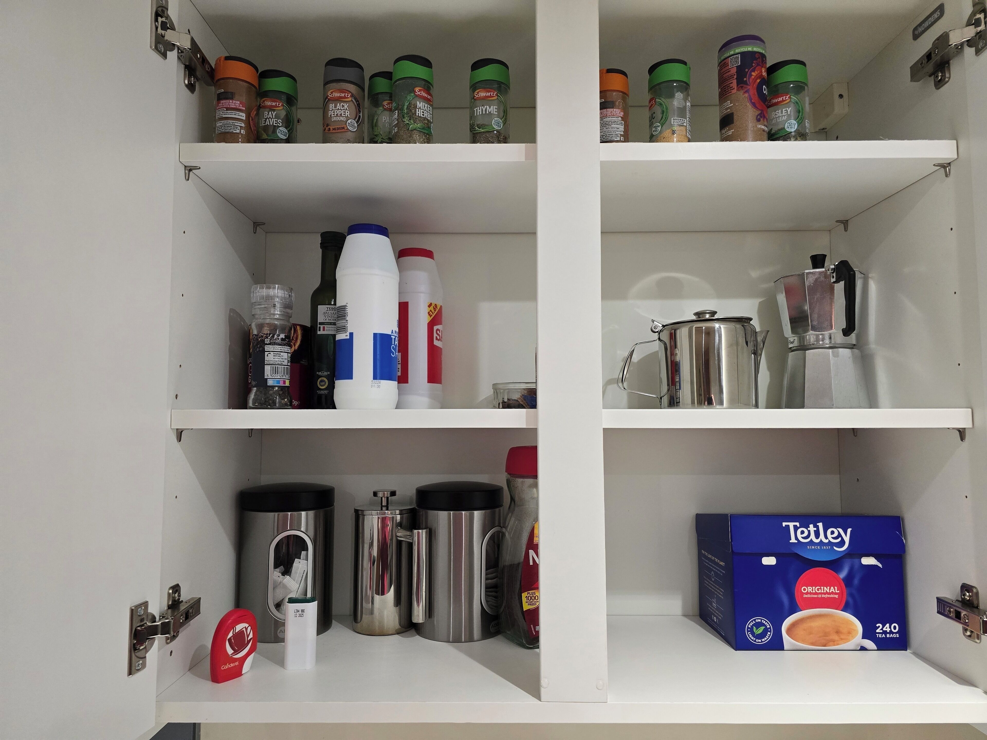 A kitchen pantry with shelves stocked with spices, condiments, and kitchenware.