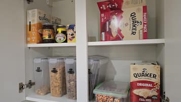 A pantry with Quaker Oatmeal, Marmite, and other food items.