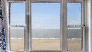 A window with a view of a beach and ocean. - Sandpiper Dunes 1009 (Ocean City)