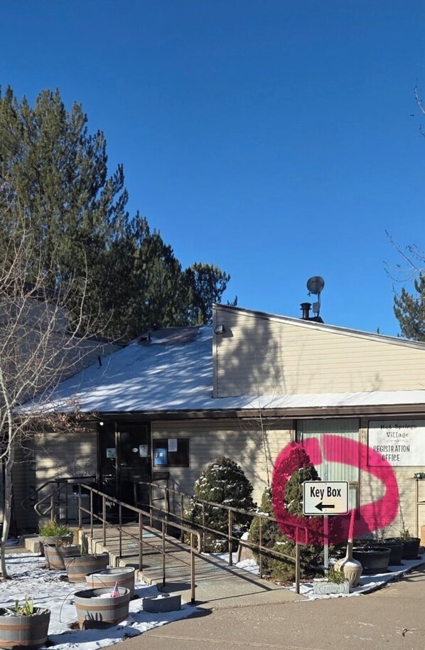 A building with a sign for a Key Box and a Registration Office.
