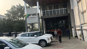 A building with a sign for 'Riddhi Paradise' hotel, featuring a modern design with a flat roof and large windows. - Staylo Masterprice Palace (Lucknow)